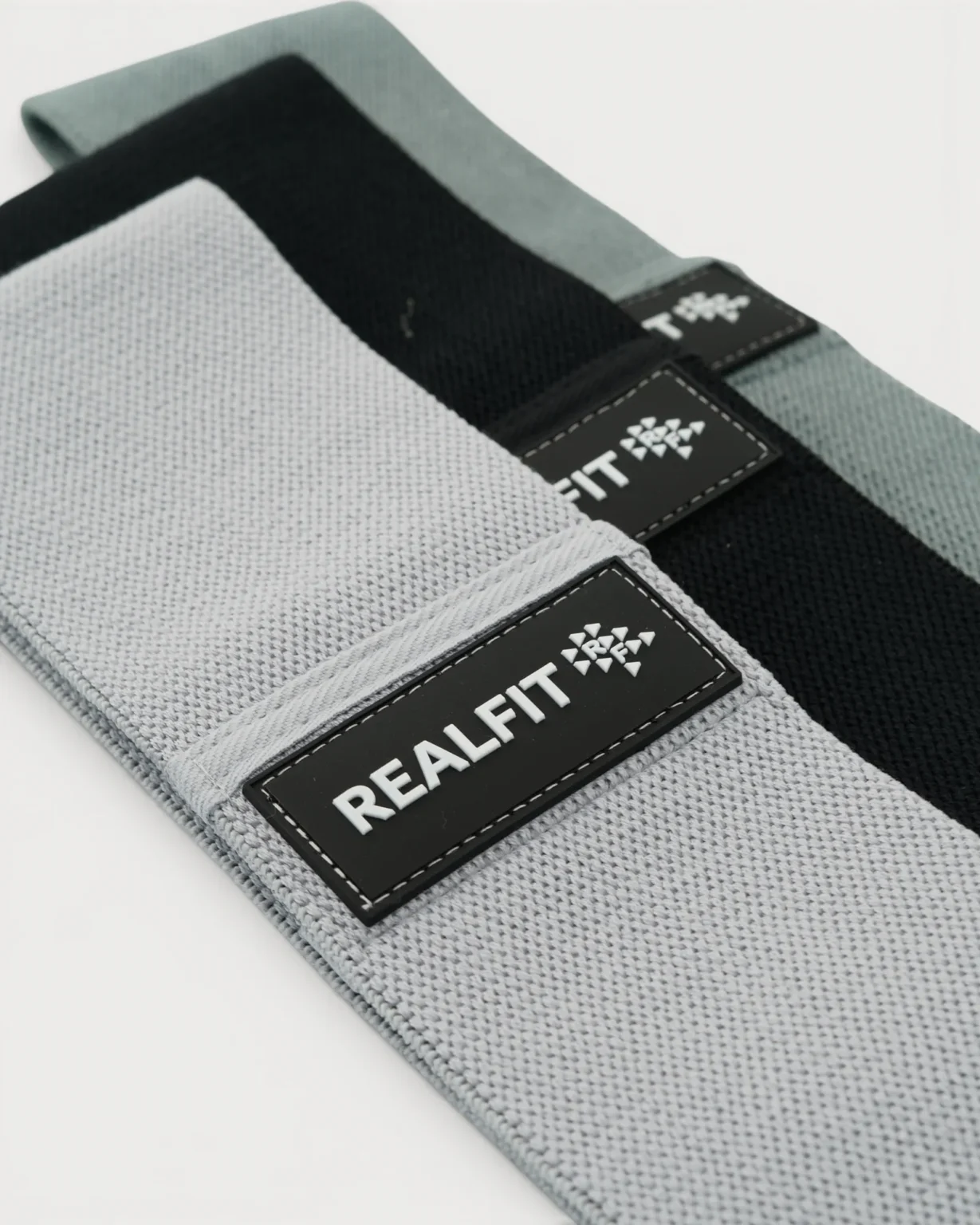 Realfit Performance Resistance Bands 3-Pack in light grey, sage green and black shown at an angle