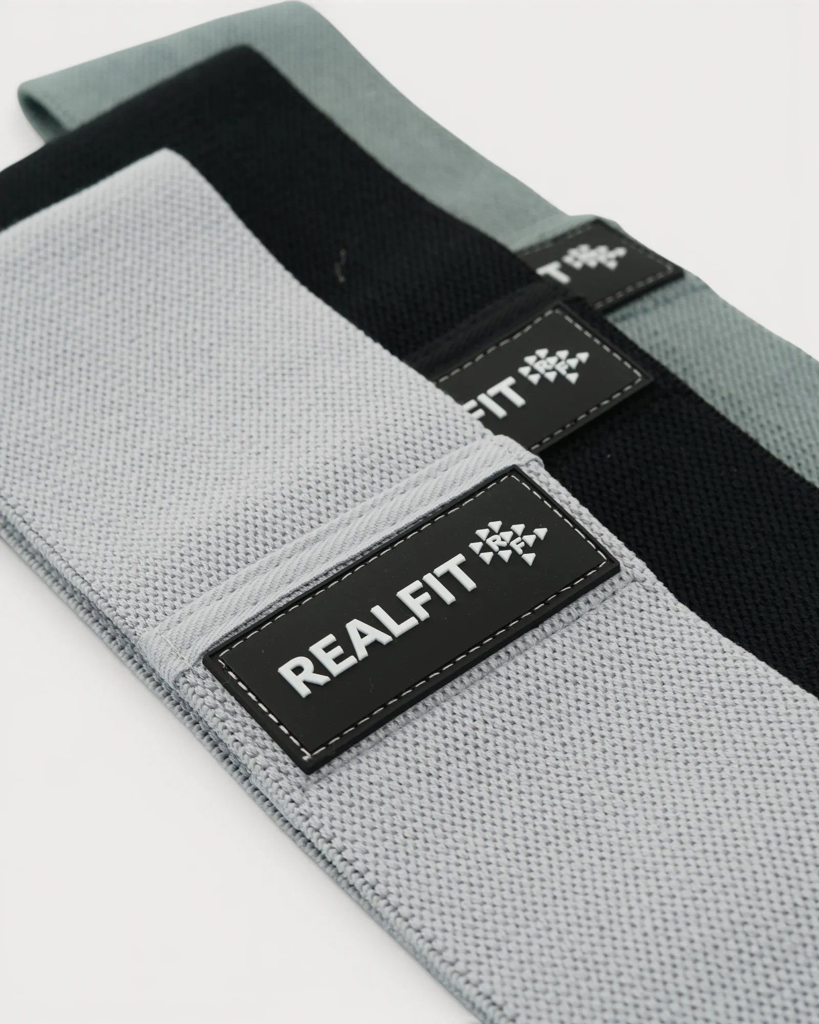 Realfit Performance Resistance Bands 3-Pack in light grey, sage green and black shown at an angle
