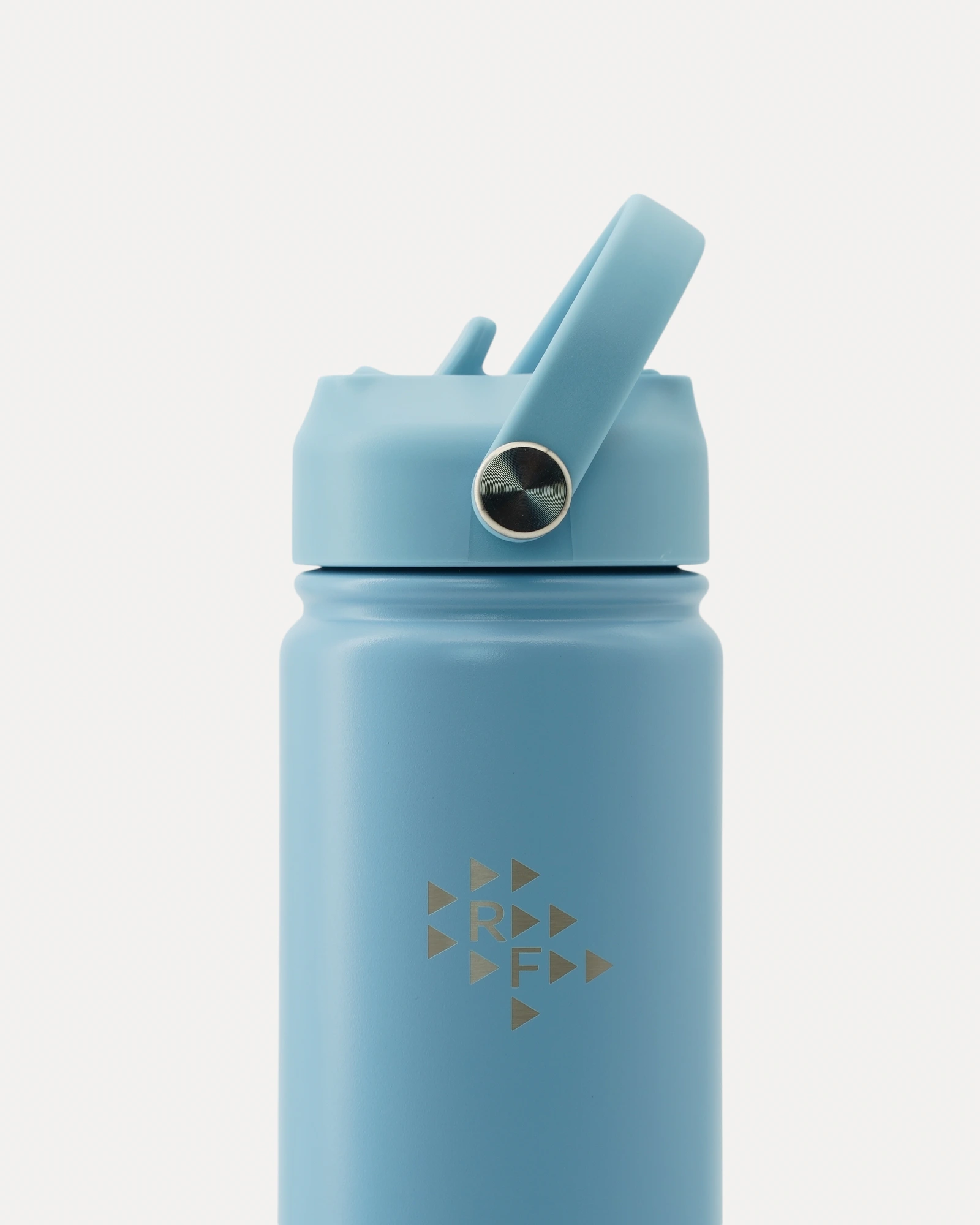 Close-up front view of Realfit Glacier Blue stainless steel water bottle with Realfit logo