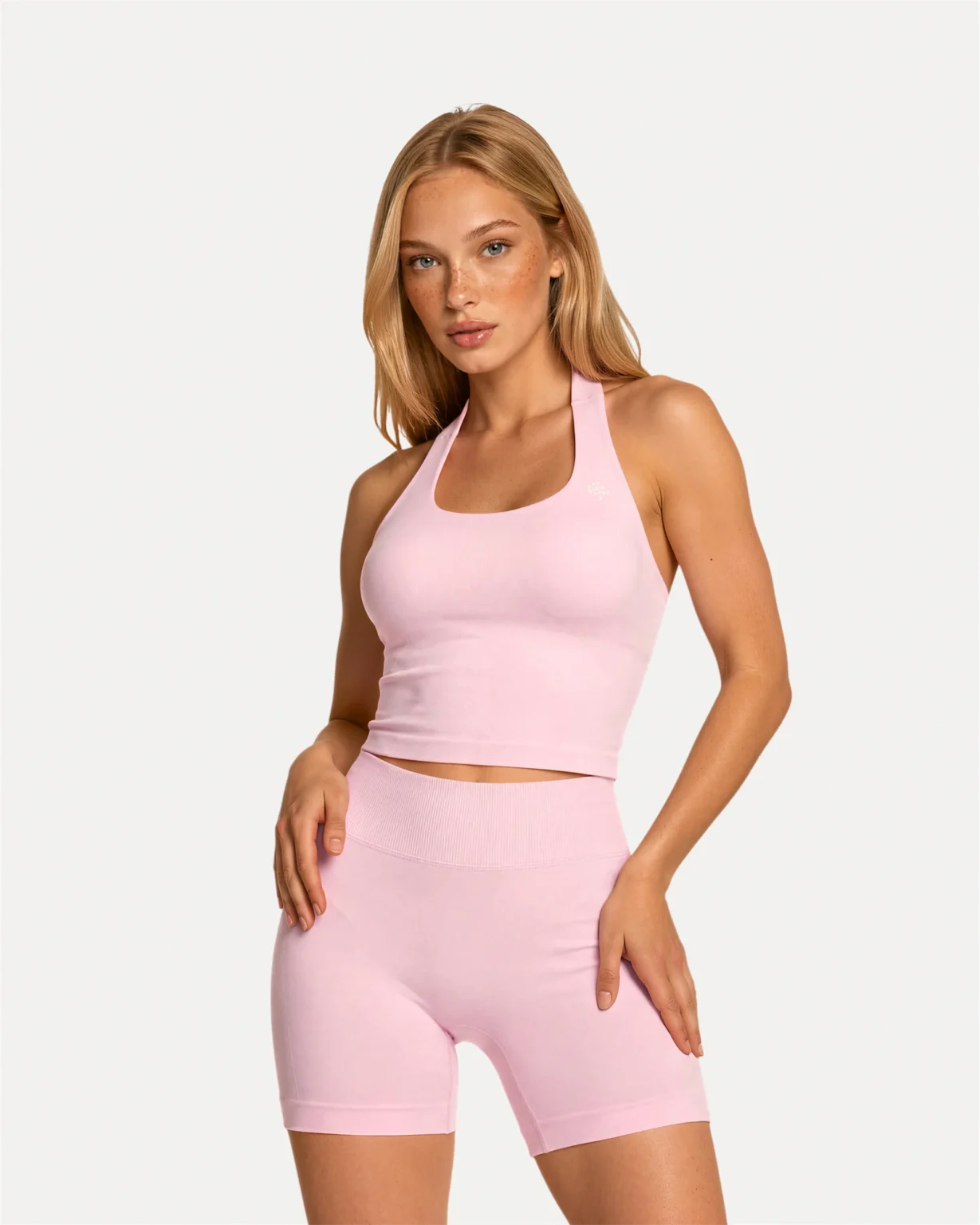 Front angled view of soft pink Realfit Core Halter Tank top for women