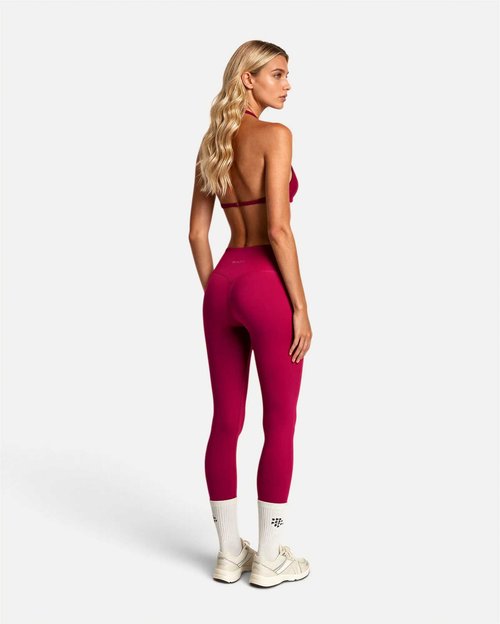 Back lifestyle view of crimson Realfit core leggings for women