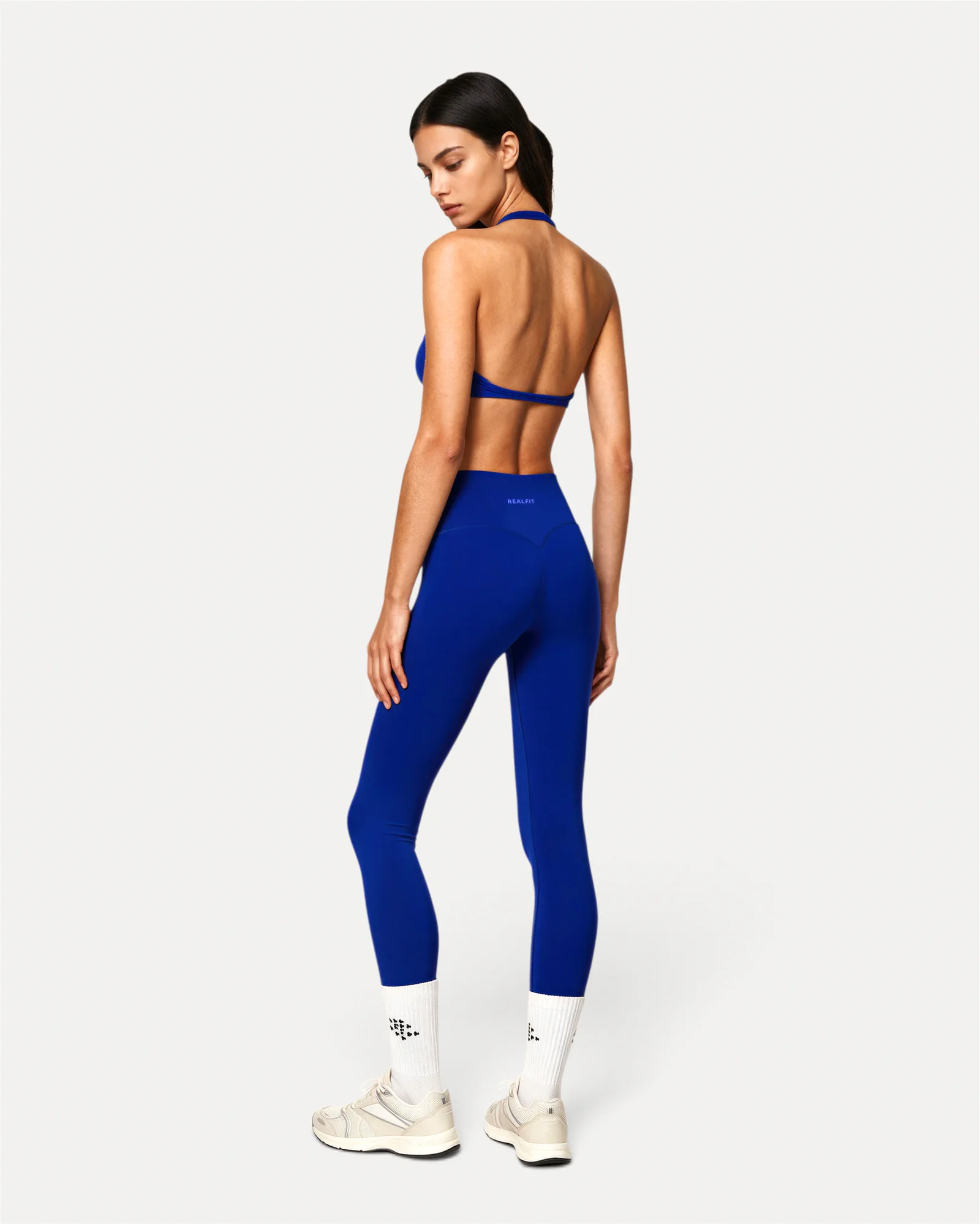 Back lifestyle view of deep blue Realfit core leggings for women