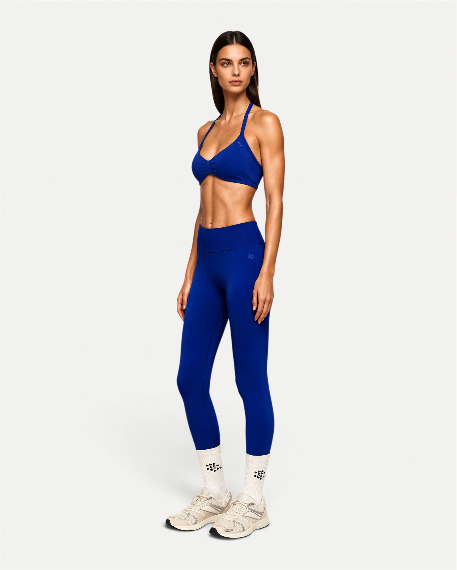 Front angled lifestyle view of deep blue Realfit core leggings for women