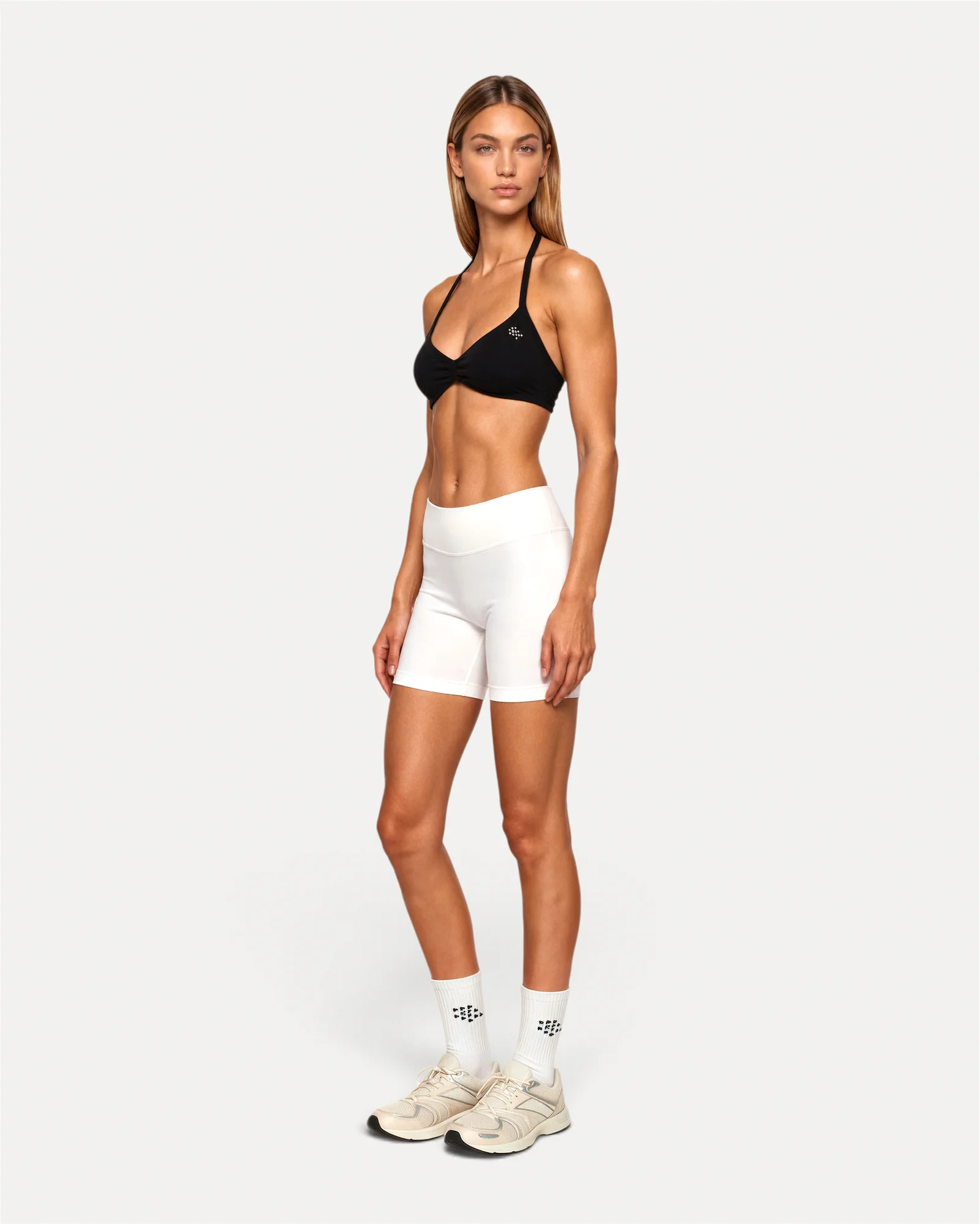 Front angled lifestyle view of midnight black Realfit ruched bra for women