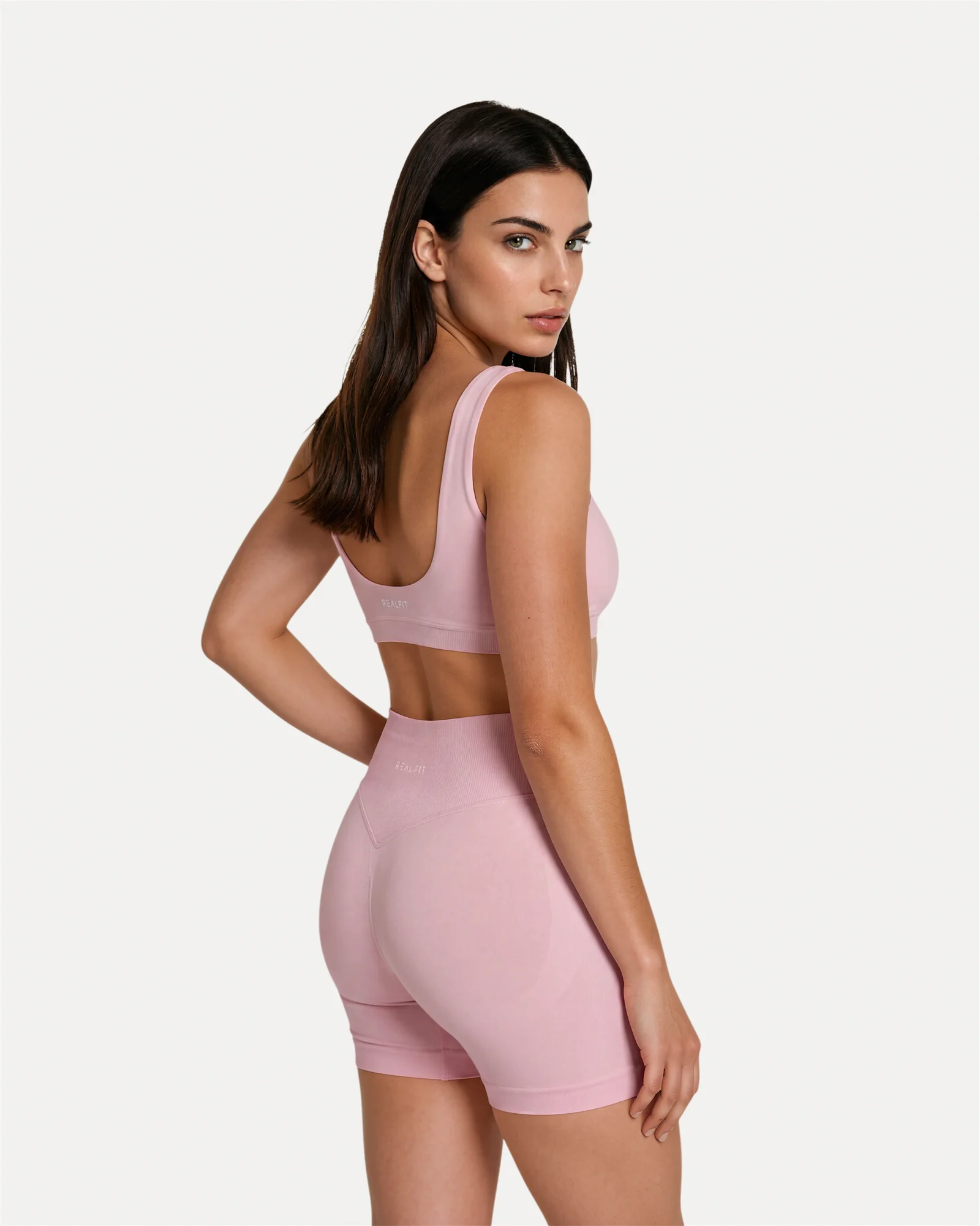 Back angled view of soft pink Realfit core scoop sports bra for women