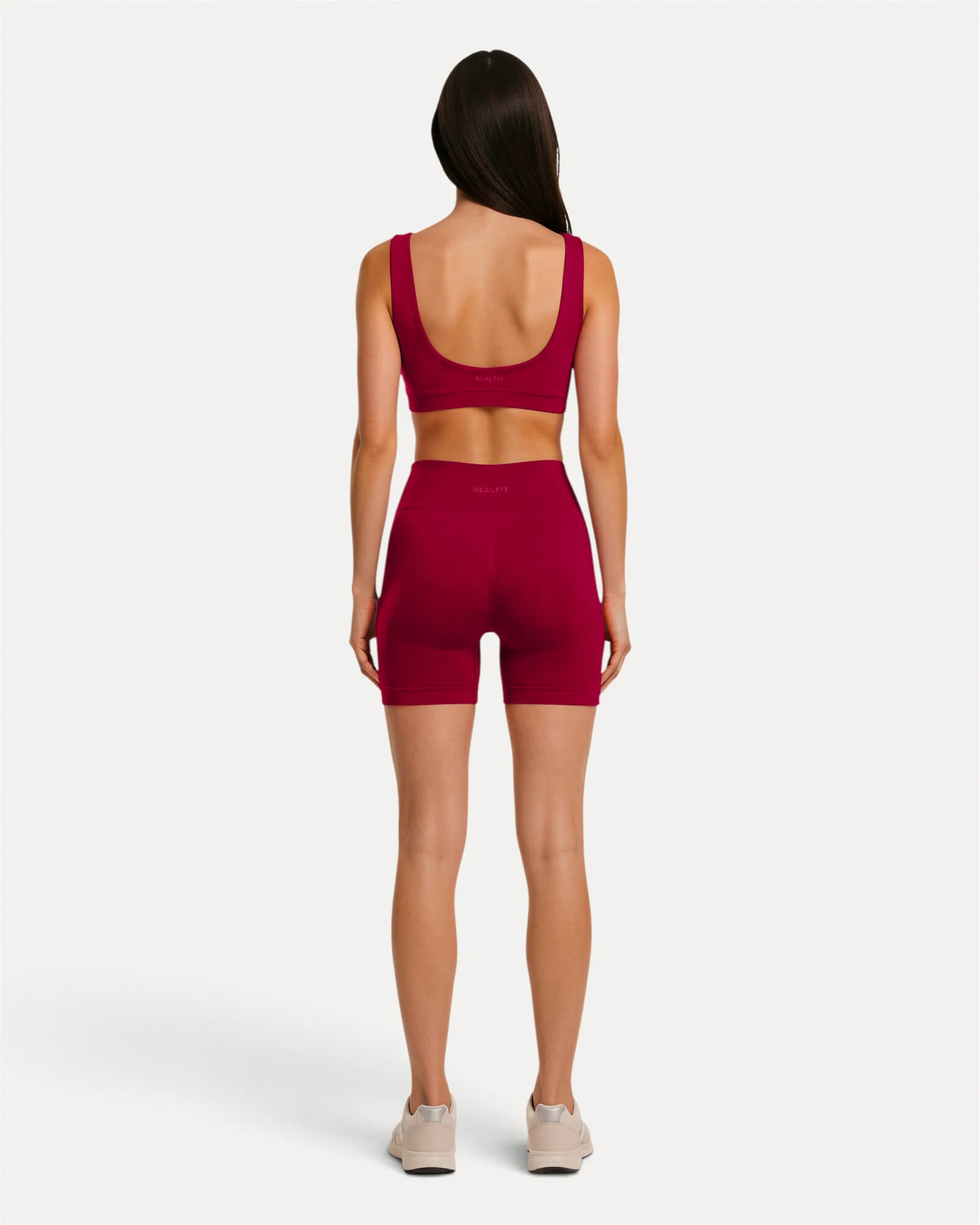 Back lifestyle view of crimson Realfit core shorts for women