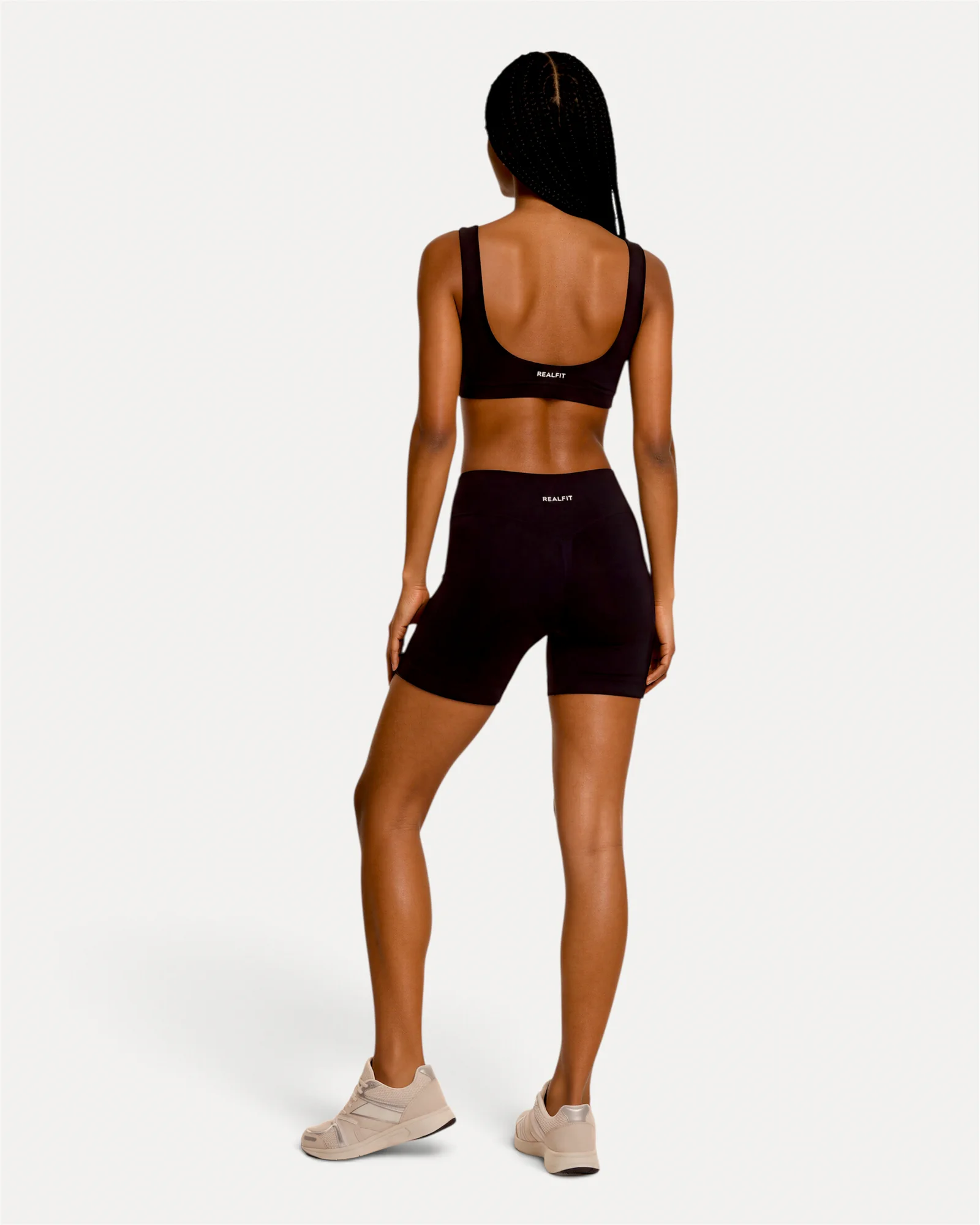 Back lifestyle view of midnight black Realfit core shorts for women