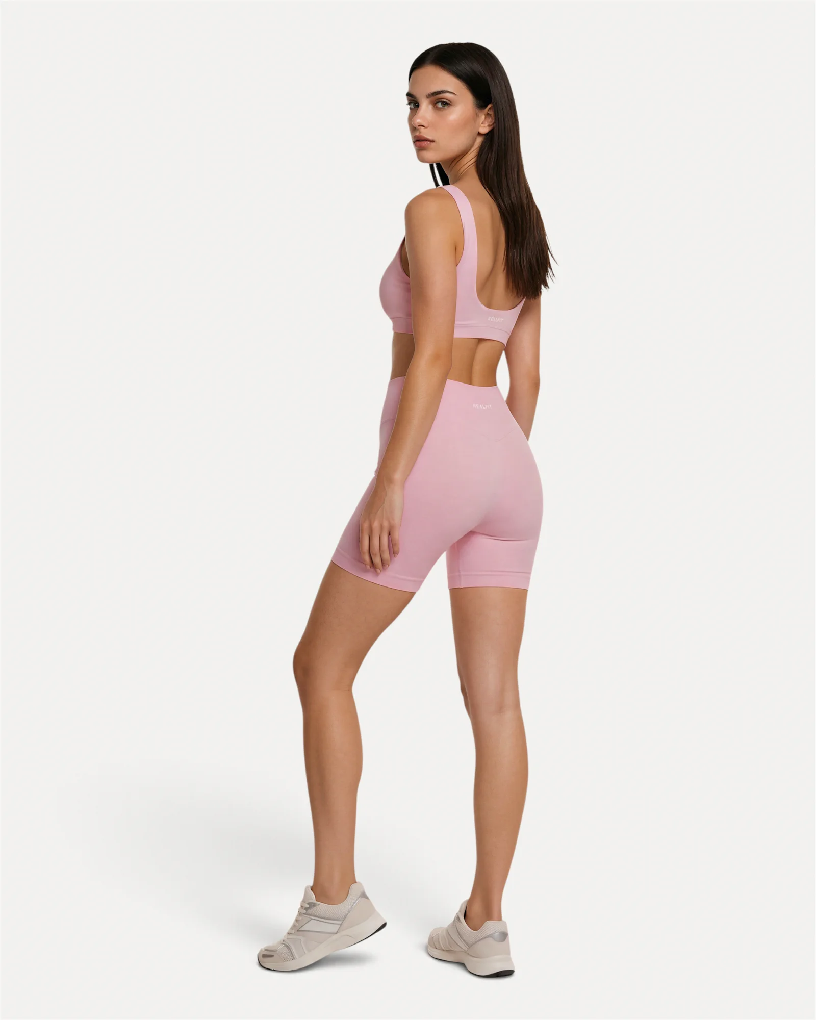 Back lifestyle view of soft pink Realfit core shorts for women
