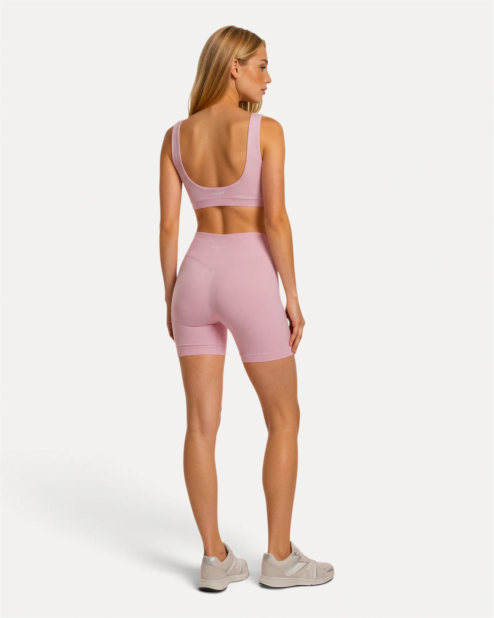 Back lifestyle view of soft pink Realfit core shorts for women