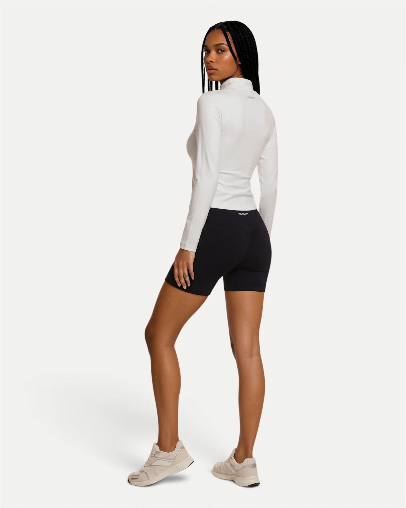 Back lifestyle view of optic white Realfit lightweight zip jacket for women