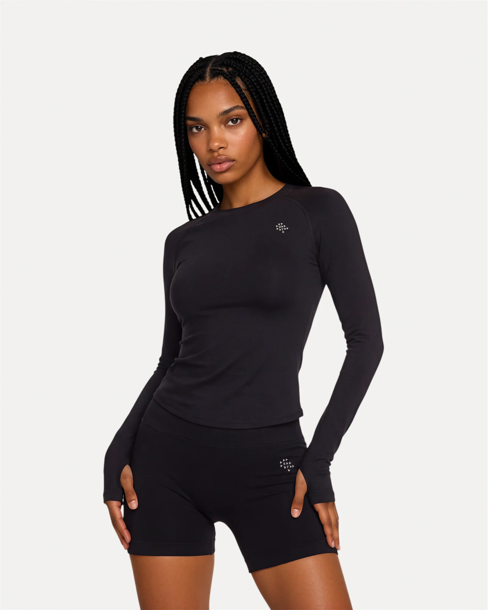 Front angled view of midnight black Realfit long sleeve top for women