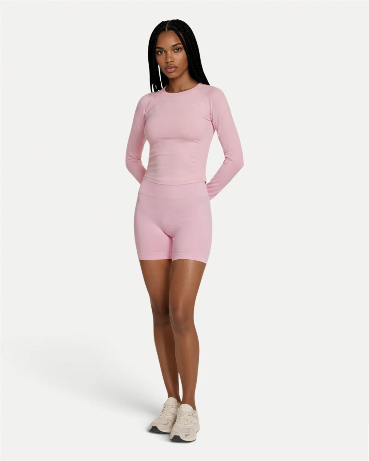 Front lifestyle view of soft pink Realfit long-sleeve top for women