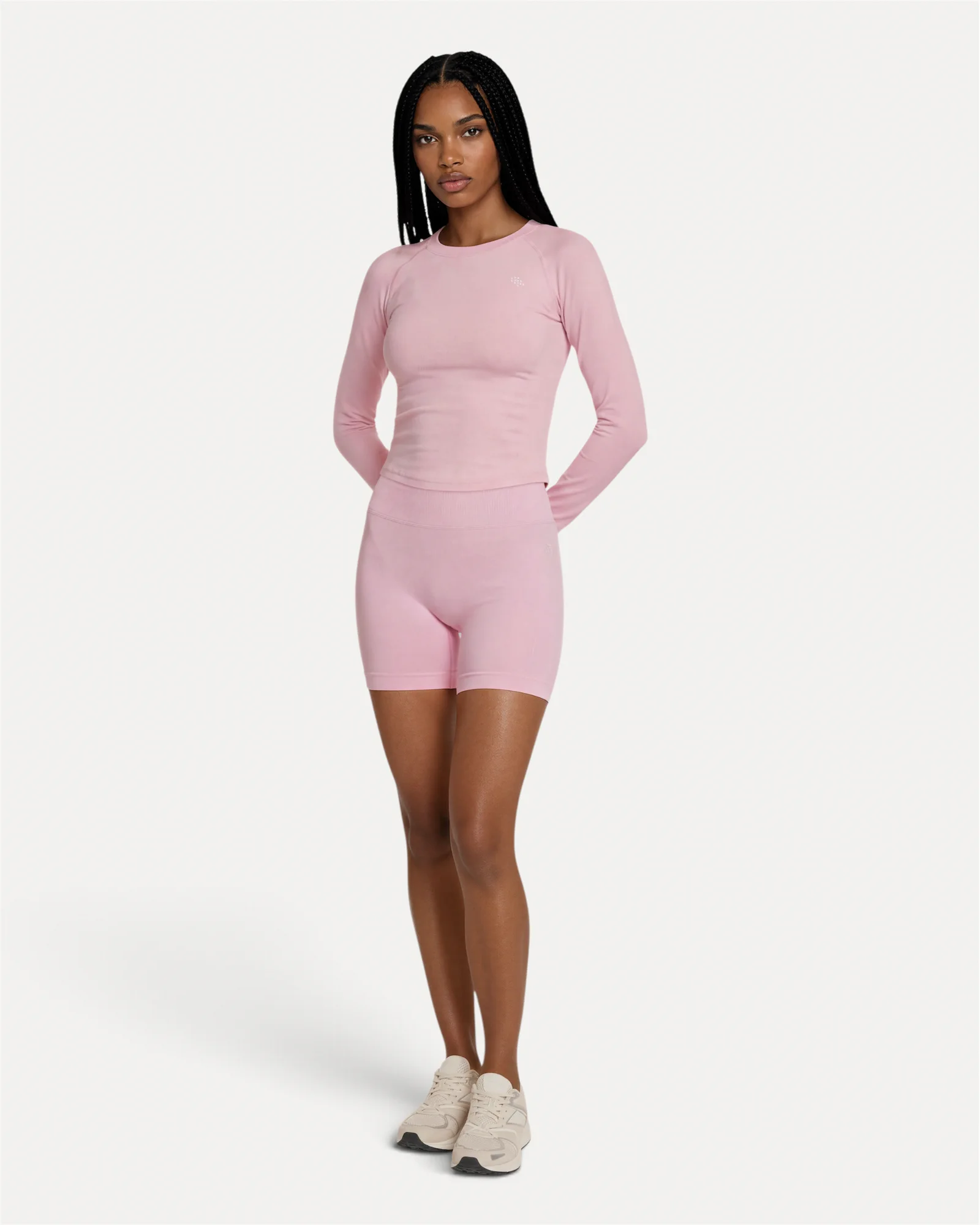 Front lifestyle view of soft pink Realfit long-sleeve top for women