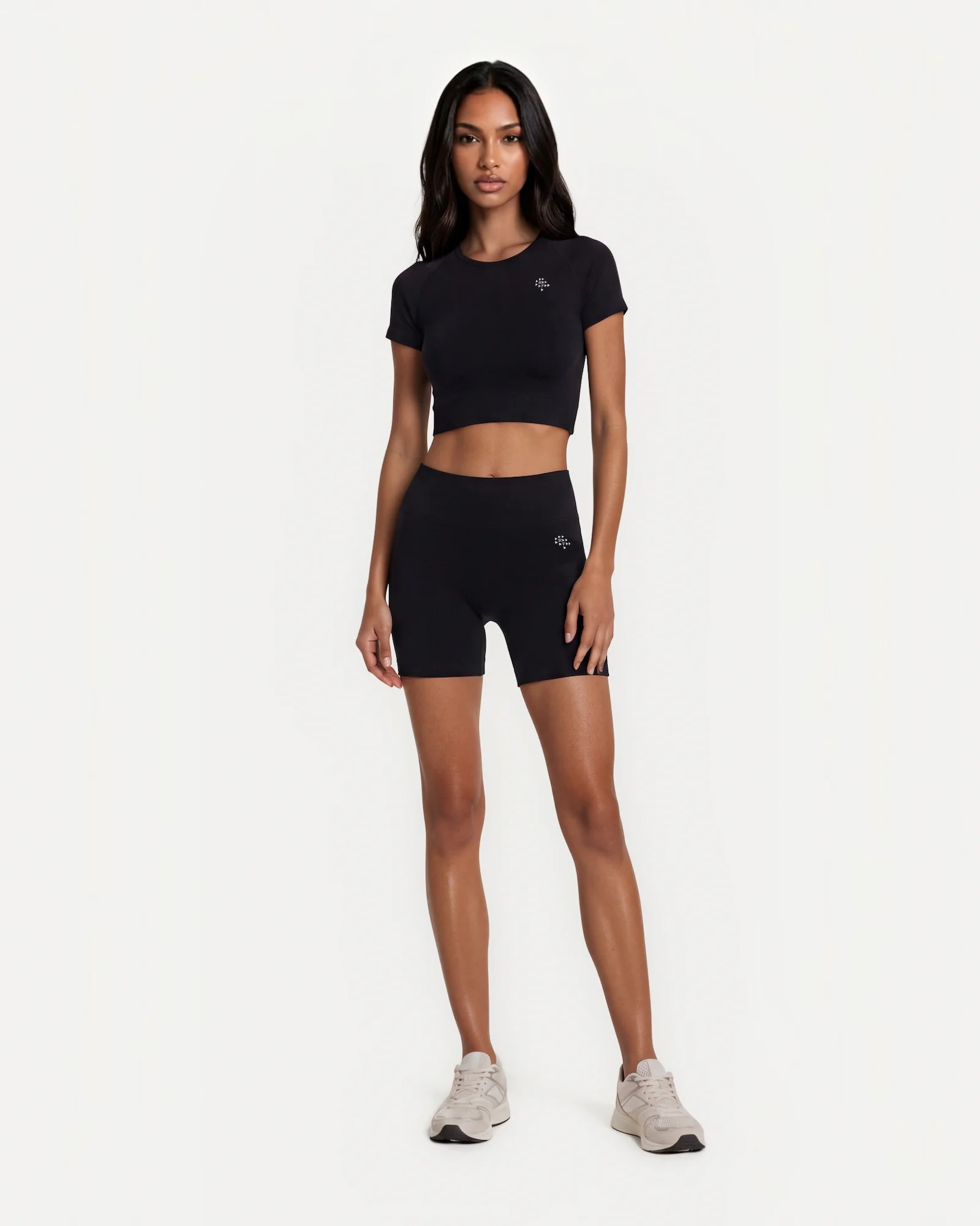 Woman wearing black Realfit short-sleeve crop top in lifestyle setting