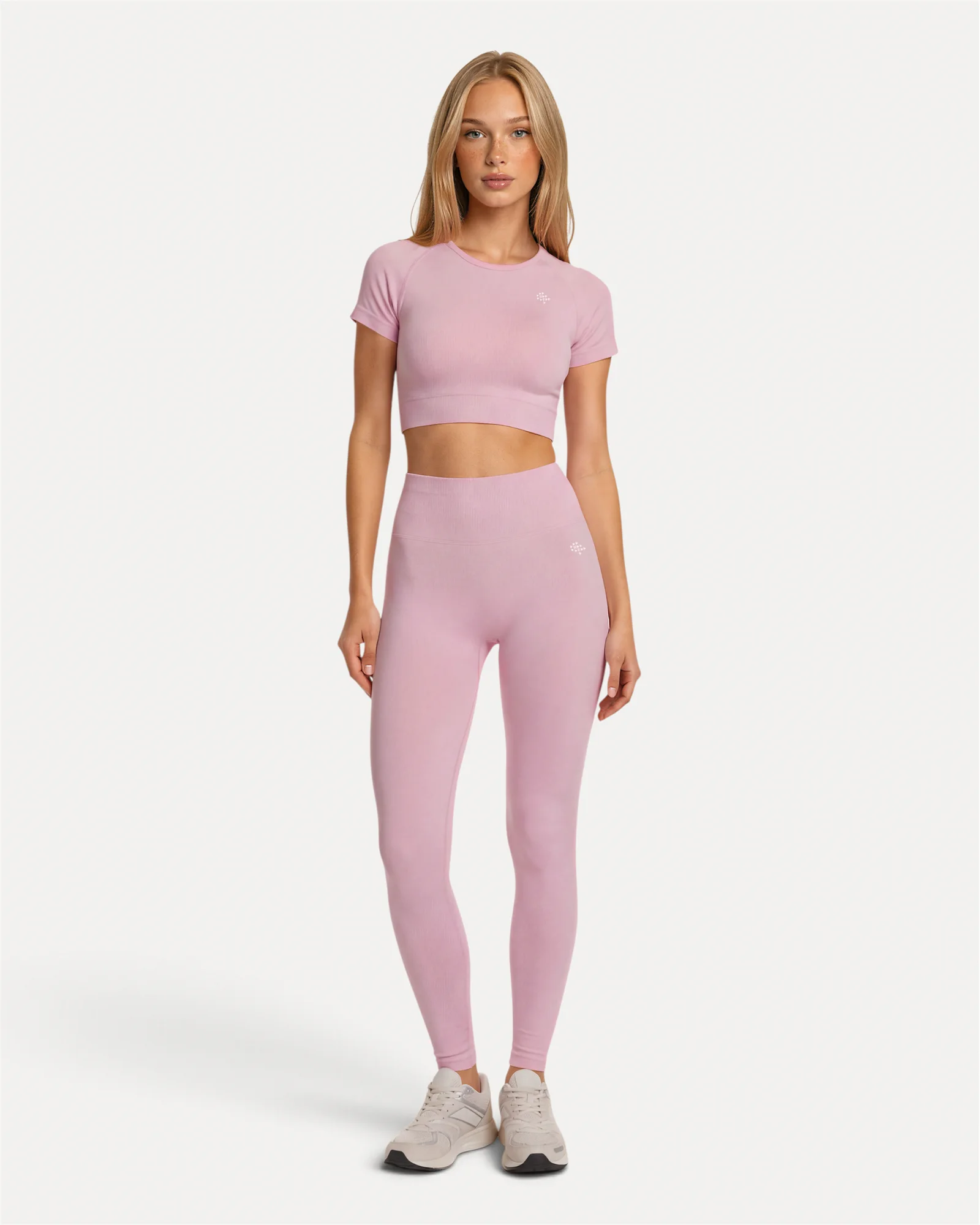 Front lifestyle view of soft pink Realfit Core short-sleeve crop top for women