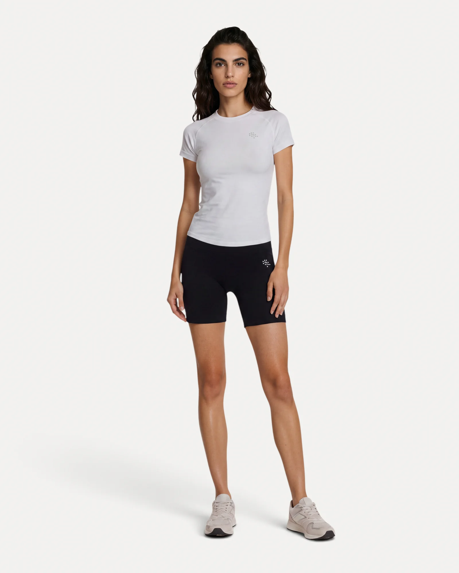 Front lifestyle view of white Realfit short-sleeve top on model